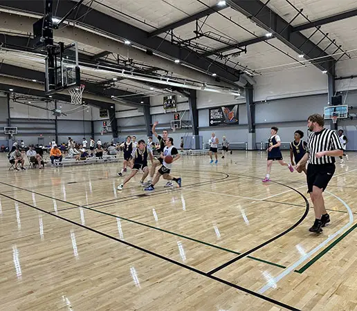 Athletes playing basketball on basketball court